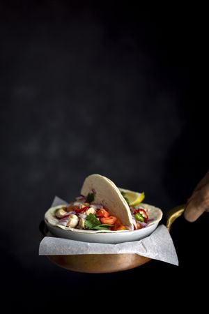 Woman's hands holding Mexican Tacos