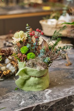 Floral composition with blooming flowers and plants on table