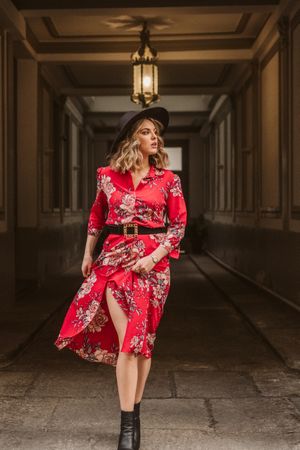 Elegant woman standing in old passage