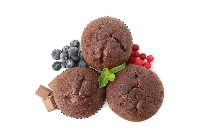 Delicious chocolate muffins isolated on blank background