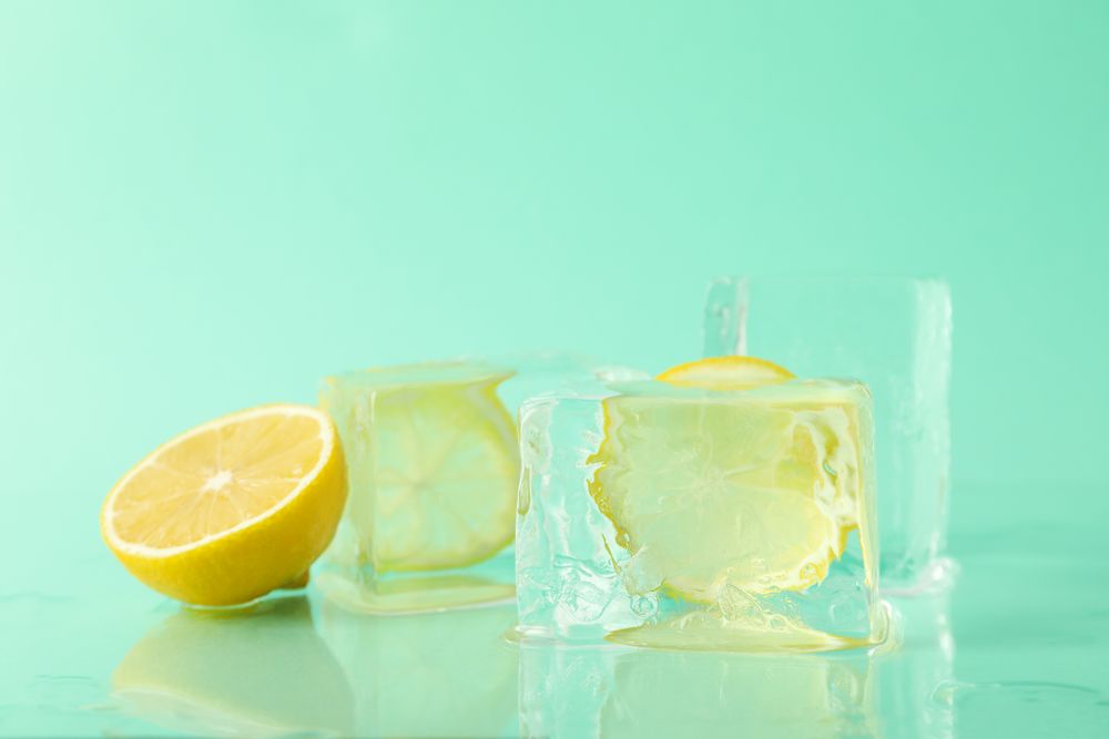 Large square ice cubes with lemon, in mint room