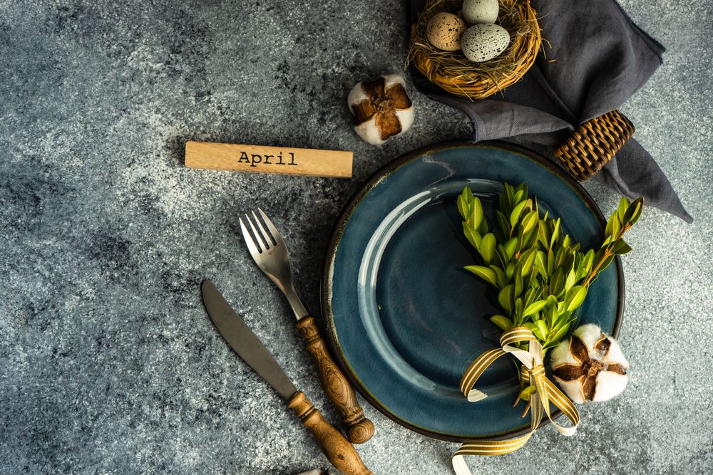 Table setting with branch and delicate nest on grey counter with copy space
