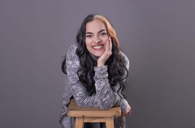 woman looking at camera with hands on face.