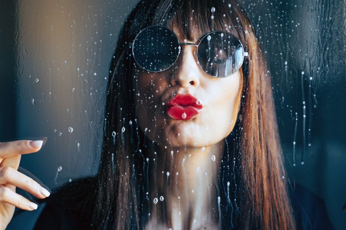 Stylish woman kissing glass