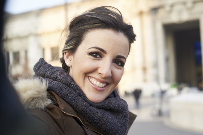 Young woman taking a selfie with smart phone outdoors