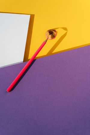 Back to school: Pink pencil on geometric background
