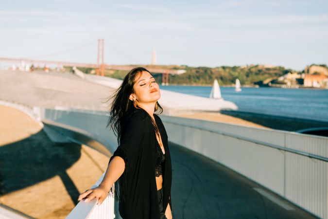 Trendy female standing on urban background