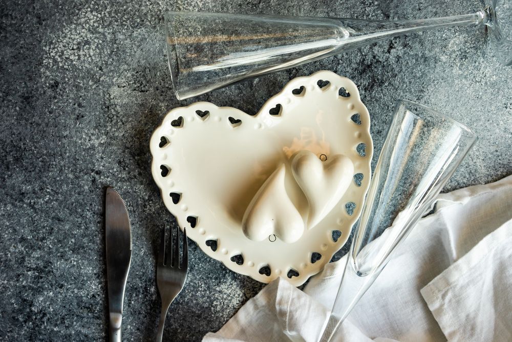 St. Valentine's Day card with heart ornaments, champagne flute and heart shaped plate