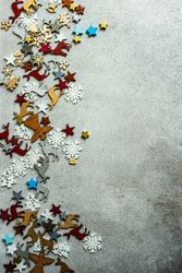 Flat Christmas ornaments scattered on concrete background