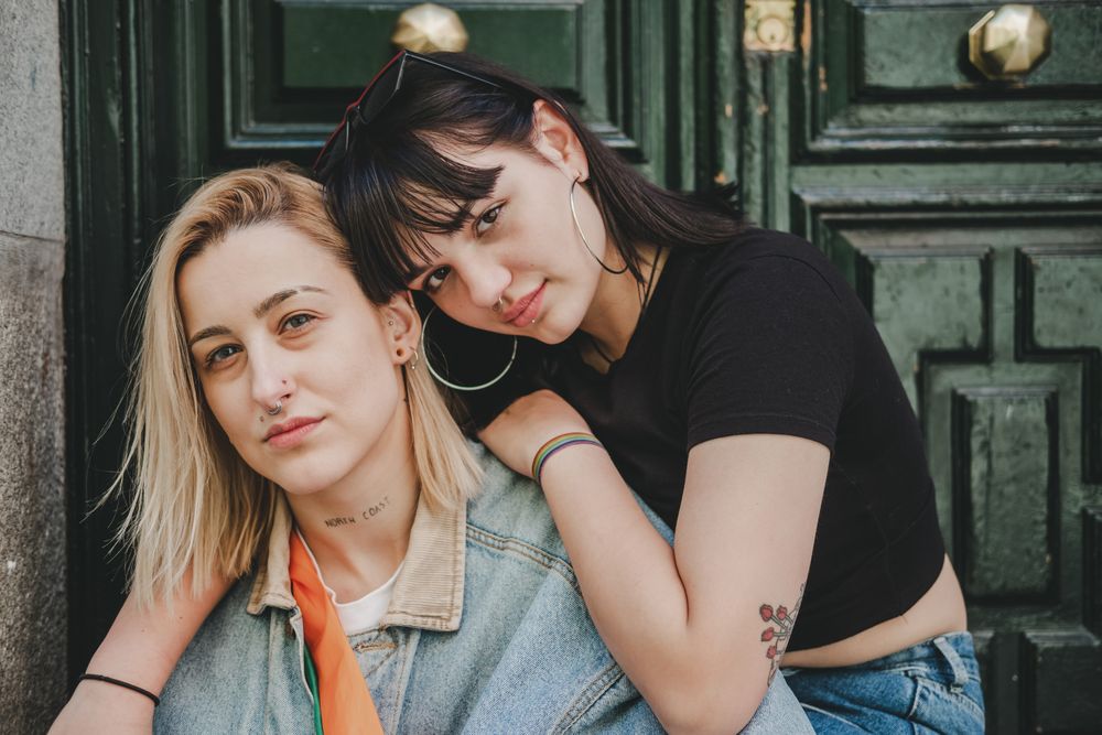 Lesbian couple sitting near door