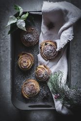 Herbs and napkin near cinnamon rolls