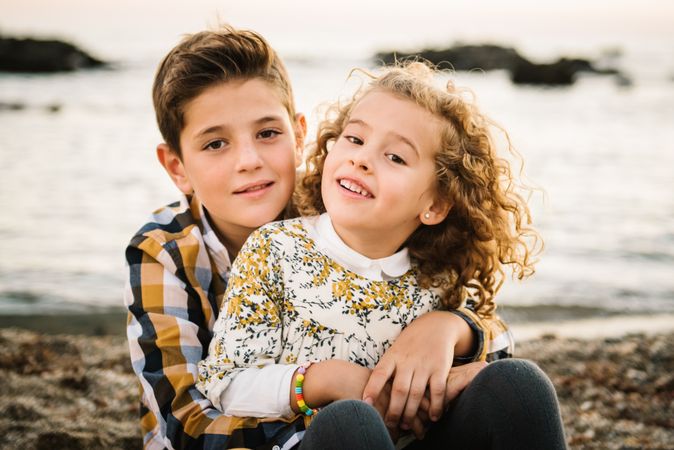 Cute boy and girl hugging each other at beach