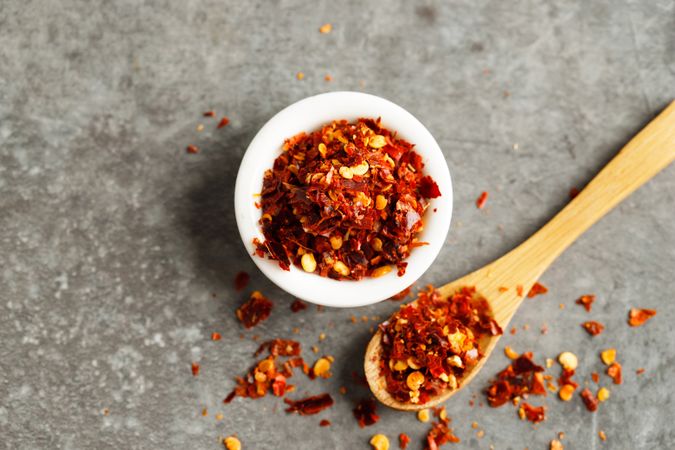 Bowl of chili flakes on marble table