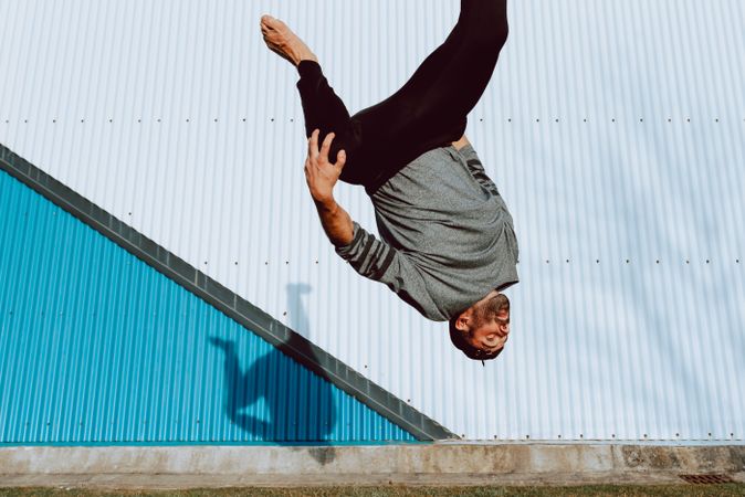 Trendy male flipping on street