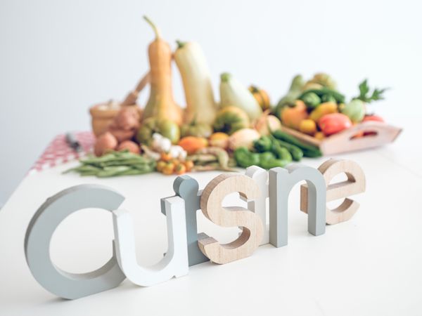 Word cuisine against fresh vegetables
