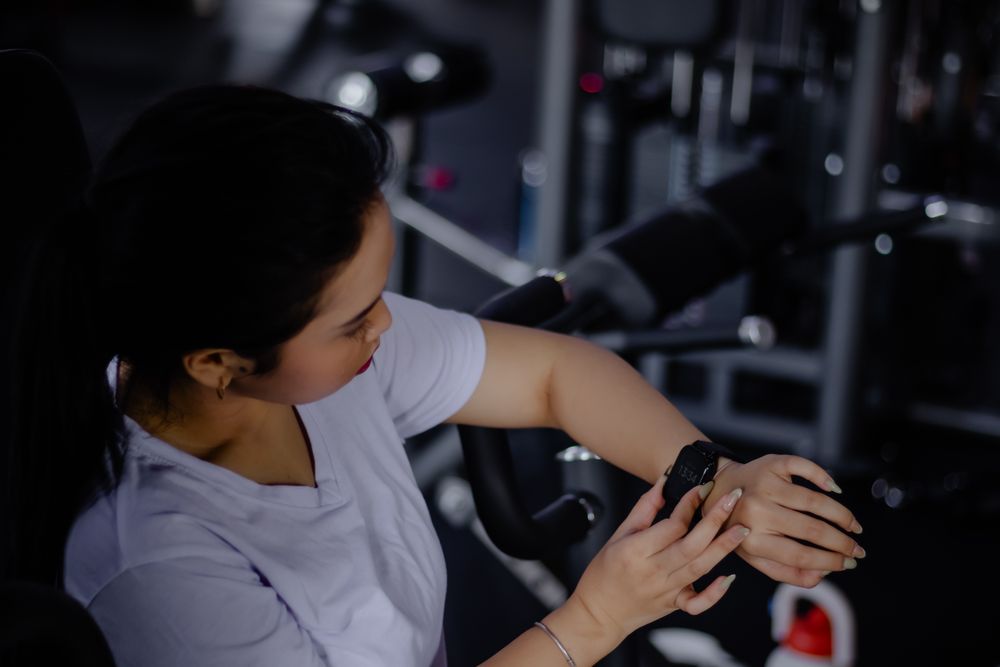 Woman Checking Fitness Tracker During Workout, Health Monitoring