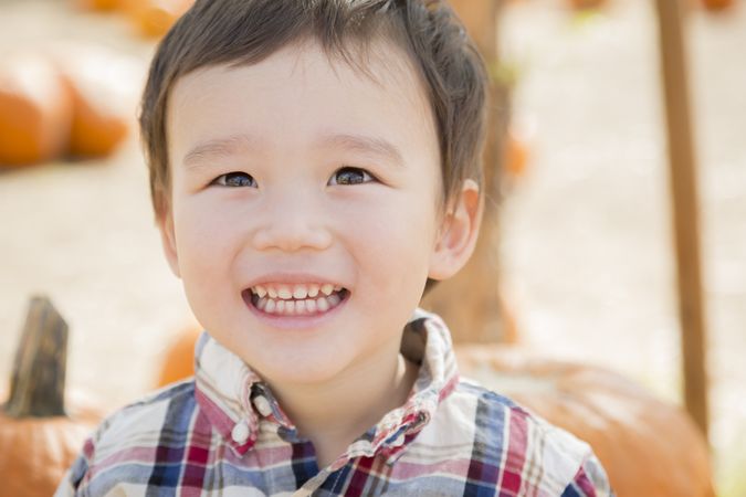 Boy Smiling and Having Fun at the Pumpkin Patch