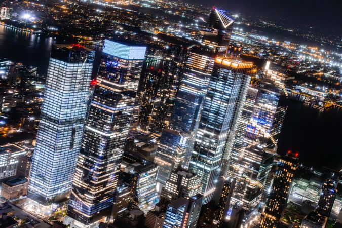 New York City Aerial Night Cityscape with Stunning Manhattan Landmarks, Skyscrapers and Residential Buildings. Wide Angle Panoramic Helicopter View of a Popular Travel Destination