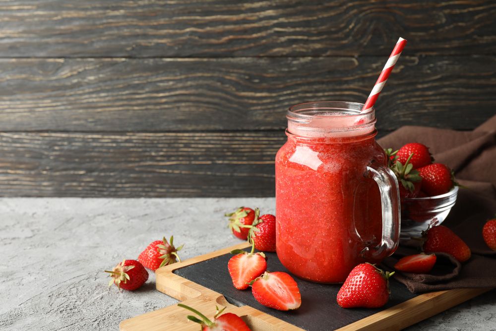 Composition with strawberry cocktail on gray table. Summer berry