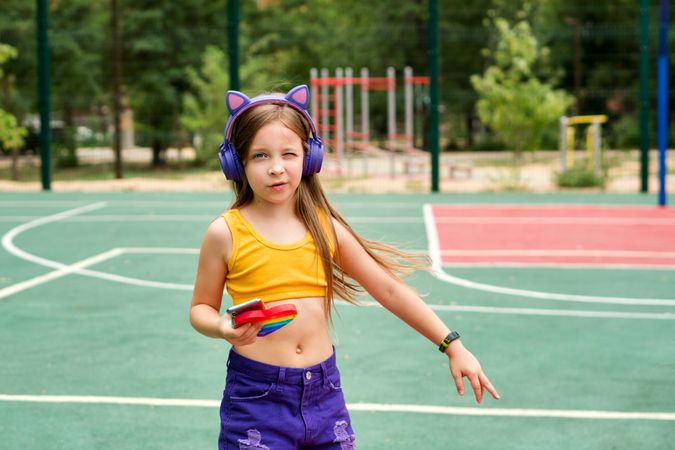 School girl with colorful pop It toy