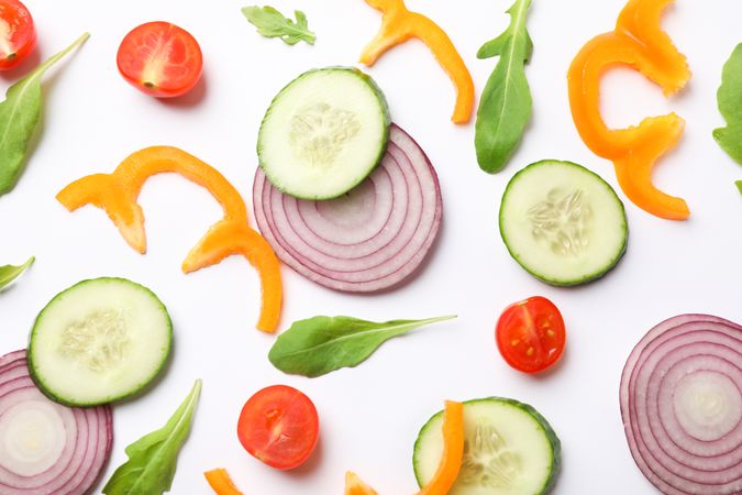 Fresh vegetables slices on plain background, top view