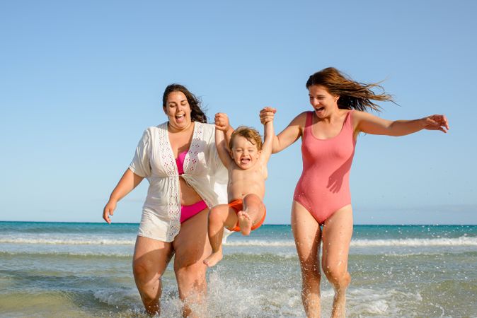 Happy family walking on beach