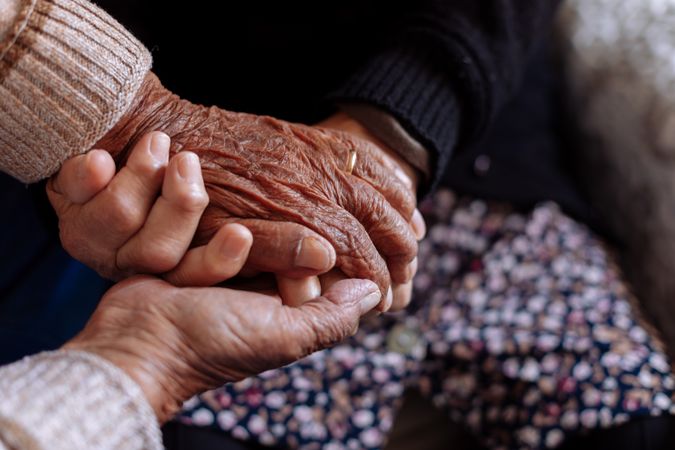 Detail of the hands of an older couple