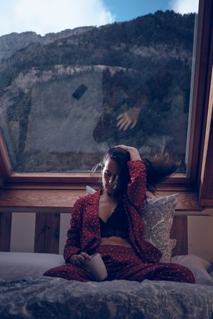 Calm woman chilling in cottage in mountains