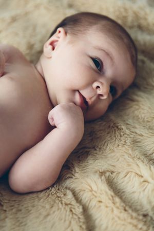 Newborn baby awake on a blanket