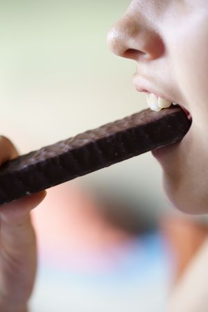 Teenager eating chocolate