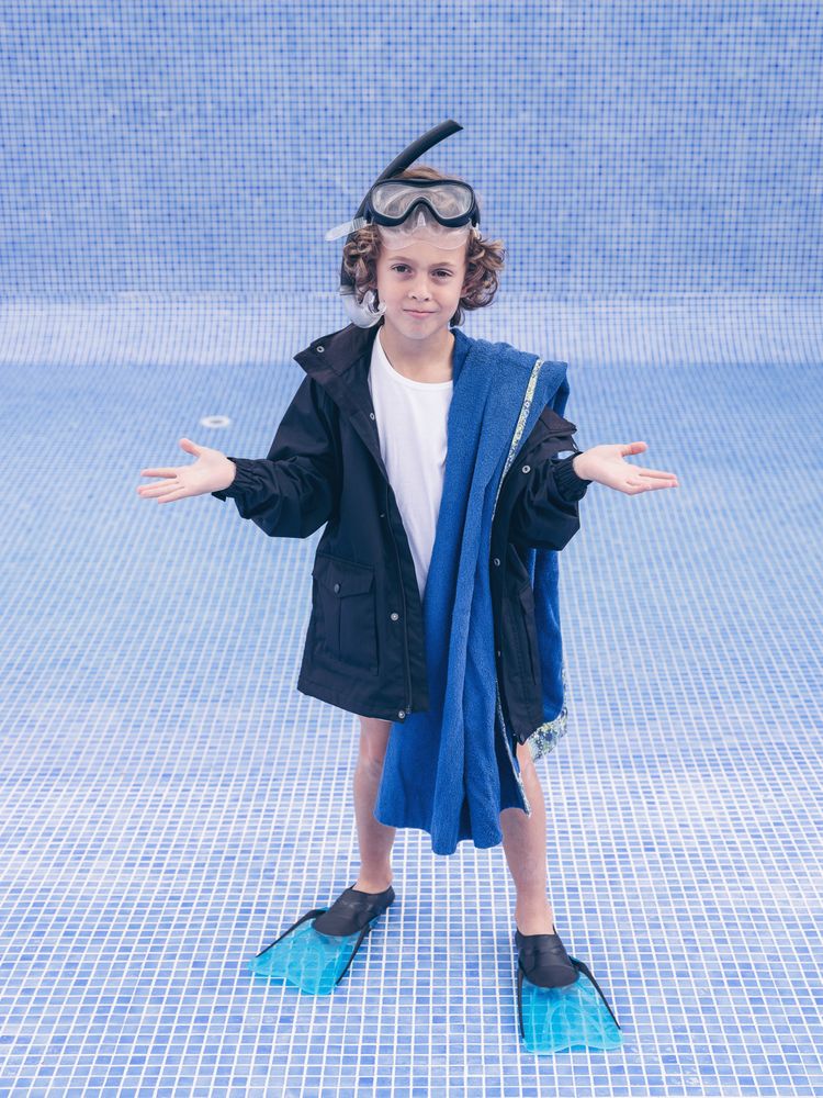 Boy in flippers and mask in empty pool