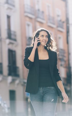 Young female walking with smartphone