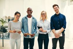 Portrait of multi-ethnic group of colleagues standing together and smiling