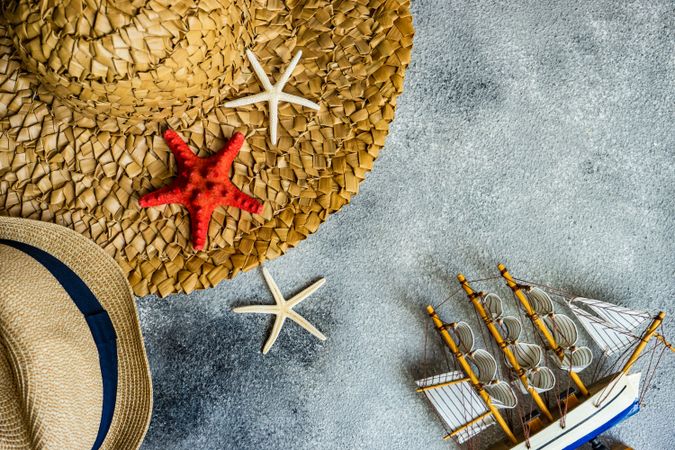 Top view of straw hat with seashells as a holiday concept