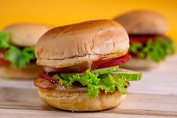 A sandwich with lettuce and tomato on top of a bun