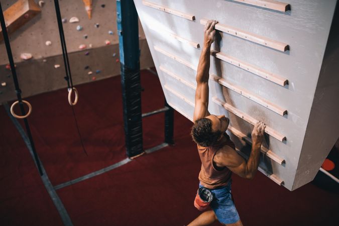 Skilled climber performing rock climbing exercises
