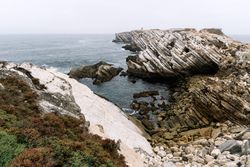 Rocky formations in the island of Baleal on the Atlantic coast in a foggy day. Peniche, Portugal