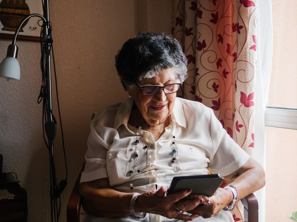 Mature female reading e-book at home