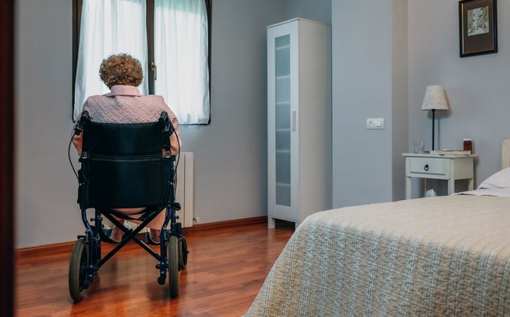 Mature woman in a wheelchair alone