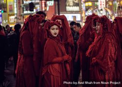 Japan - Tokyo, Shibuya Japan - November 29th, 2019: Woman in Red Rebel Brigade looking back 4d8WL4