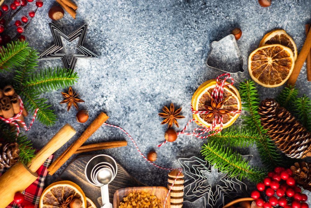 Top view of Christmas baking spices and cookie cutters on counter
