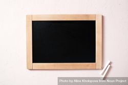 Blank chalkboard with two pieces of chalk 47DQOb