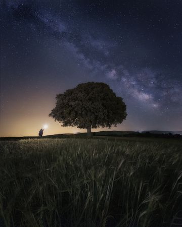 Starry sky and person with ray of light
