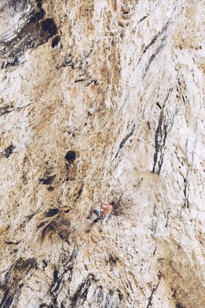 Anonymous man climbing rock
