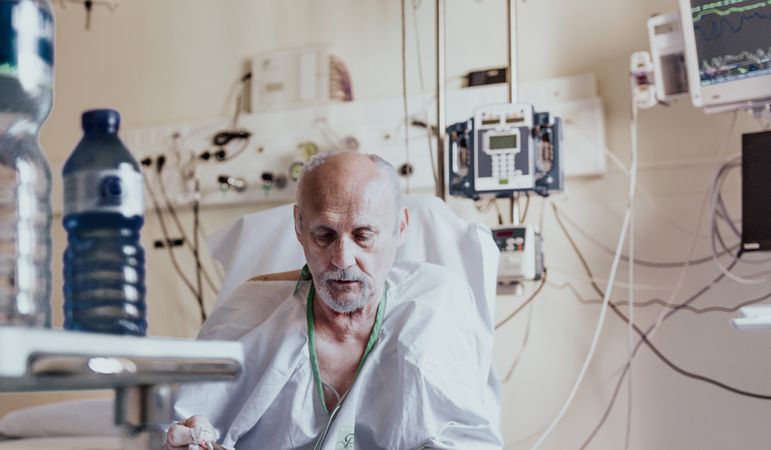 Older man admitted to a hospital room.