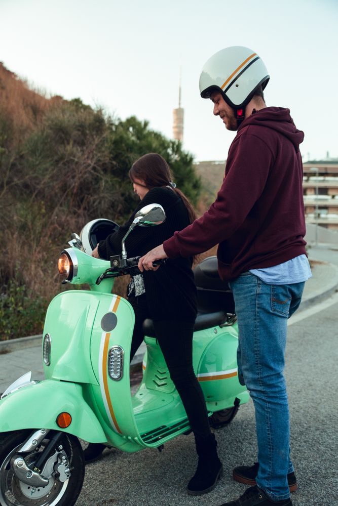 Man helping woman sit to bike