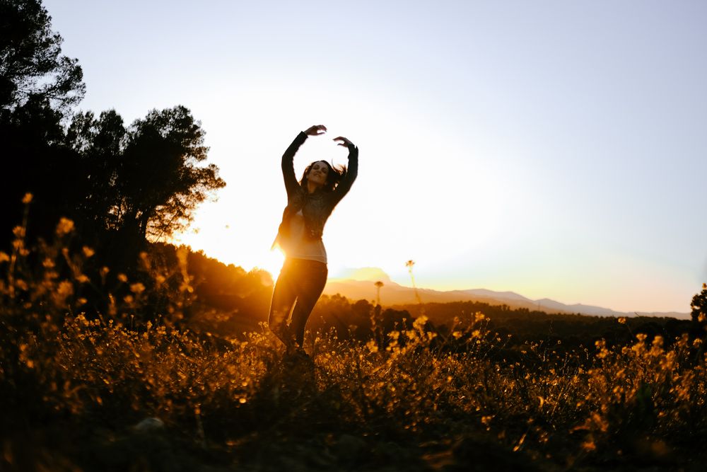 Woman walking on meadow and enjoying freedom