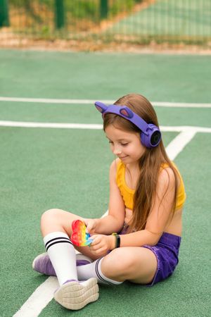 School girl sitting with toy
