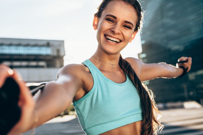 Smiling woman stretching outdoors