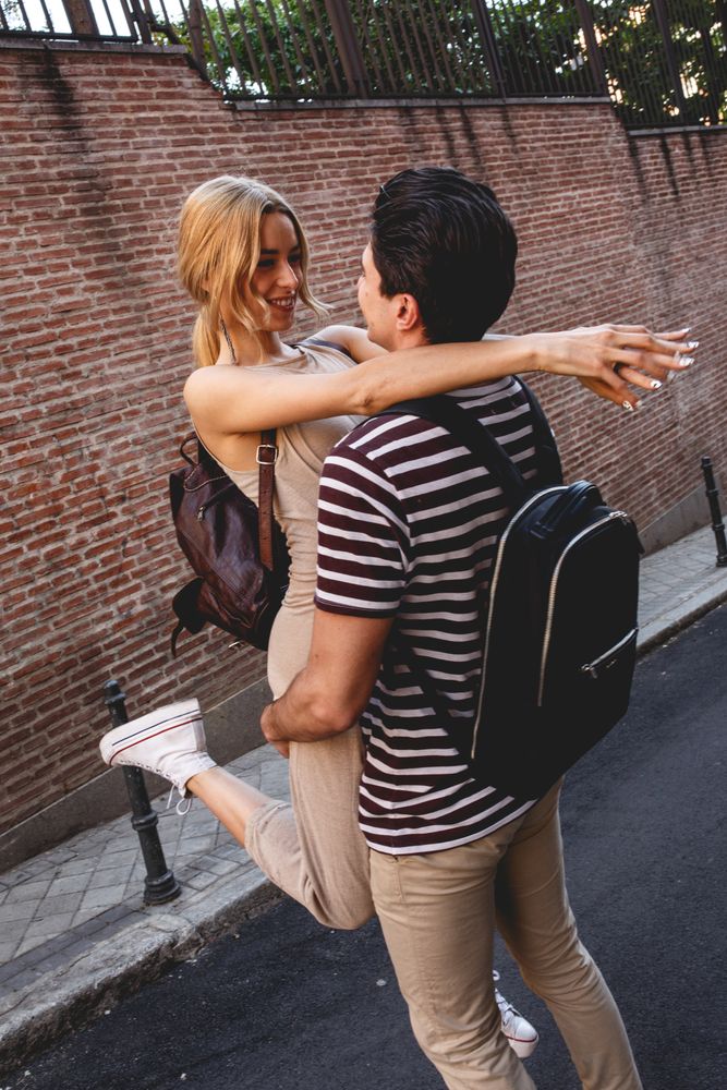 Happy couple having fun while walking in town